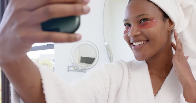 Smiling Woman Taking Selfie in Bathrobe with Eye Masks - Download Free Stock Images Pikwizard.com