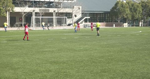 Youth Soccer Players Competing on Field Displaying Teamwork
