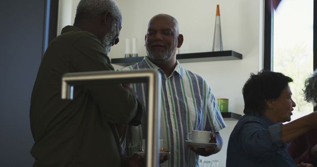 Smiling senior African American friends enjoying conversation indoors - Download Free Stock Images Pikwizard.com