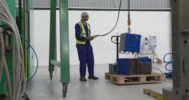 Factory Worker Operating Overhead Crane in Manufacturing Facility - Download Free Stock Images Pikwizard.com