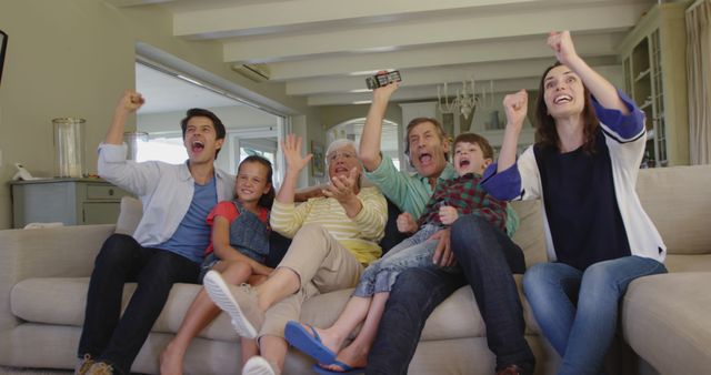 Happy Family Cheering While Watching Television at Home - Download Free Stock Images Pikwizard.com