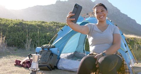 Joyful Woman Taking Selfie During Mountain Camping Adventure