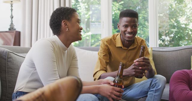 Happy Friends Enjoying Drinks on Comfortable Couch in Cozy Living Room - Download Free Stock Images Pikwizard.com