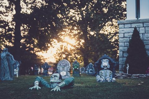 Eerie cemetery with humorous frankenstein decoration during sunset