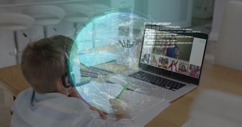 Young student learning remotely with headset and laptop, augmented globe hologram overlay