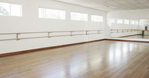 Empty Sunlit Dance Studio with Wooden Floors