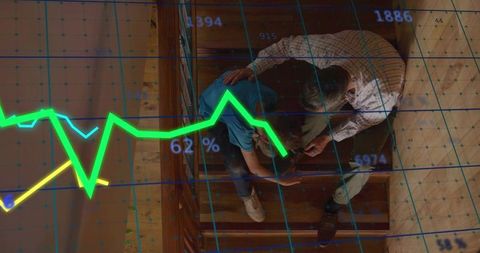 Middle-aged man showing child smartphone with financial chart overlay on wooden stairs