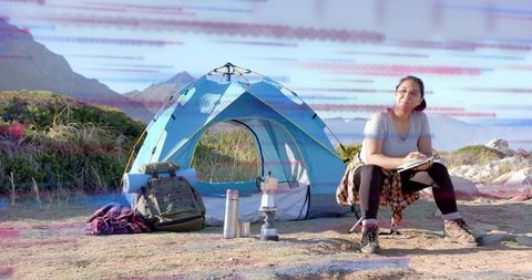 Adventure Camper Woman Writing Notebook at Scenic Mountain Camp