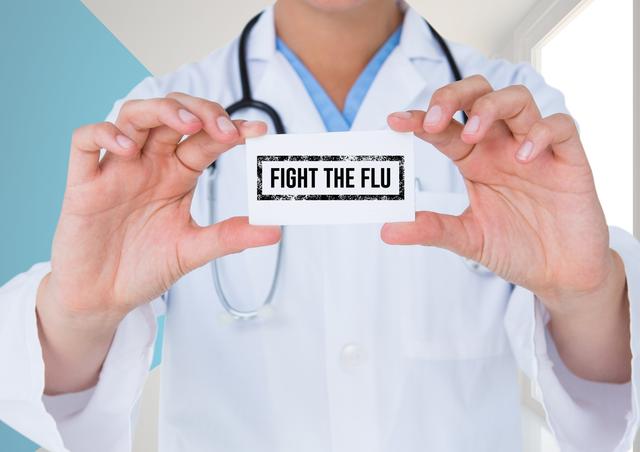 Mid-section of doctor holding placard with text fight the flu text