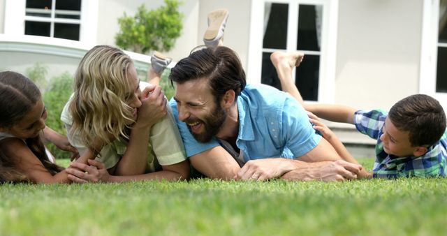 Happy Family Enjoying Time Together Laughing on Grass Lawn - Download Free Stock Images Pikwizard.com