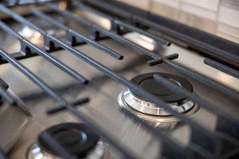 Modern Stainless Steel Gas Stove and Cast Iron Grate Close-Up