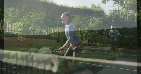 Athletic Woman Ready to Return Shot on Outdoor Tennis Court