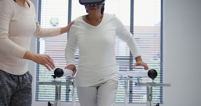 Elderly Woman Using VR for Physical Rehabilitation with Professional Support - Download Free Stock Images Pikwizard.com