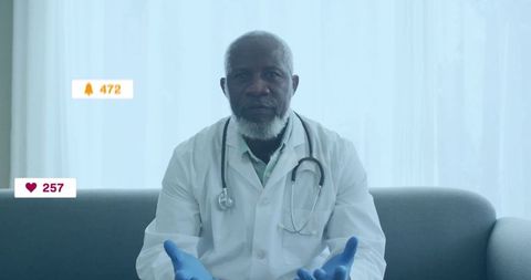 Senior doctor viewing social media notification icons in clinic