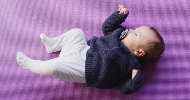 Image of caucasian newborn baby sleeping on violet blanket. newborn, infant, childhood and motherhood concept digitally generated image.
