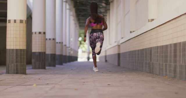 Fit Woman Running Through Urban Corridor for Fitness Exercise - Download Free Stock Images Pikwizard.com