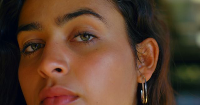 Close-Up of a Woman's Face with Natural Makeup and Hoop Earrings - Download Free Stock Images Pikwizard.com