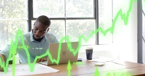 Business Professional Analyzing Financial Charts in Modern Office