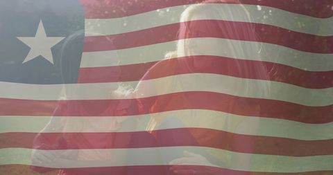 Mother and Daughter Enjoying Outdoor Picnic under Flag Overlay