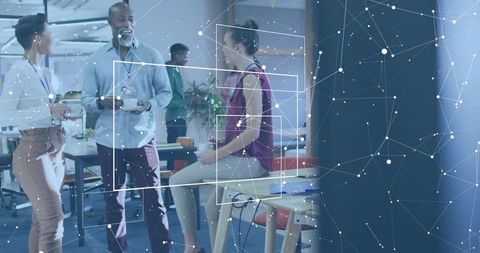 Coworkers chatting and collaborating in modern open-plan office with network overlay