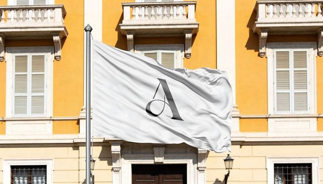 Waving white flag with letter a monogram before ochre historic facade and balconies