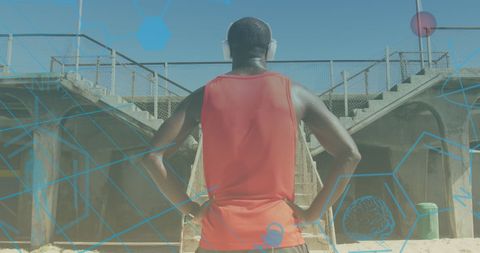 Fit African American Man with Headphones at Grungy Outdoor Gym