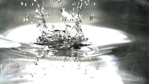 Green Apple Splashing Into Water in Slow Motion