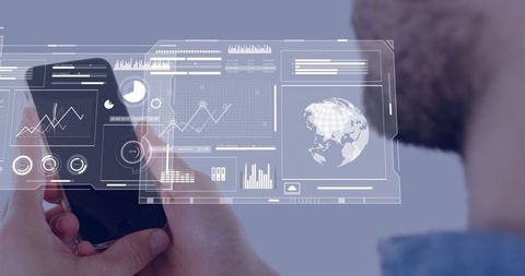 Holding smartphone displaying holographic data dashboard with globe and analytics HUD