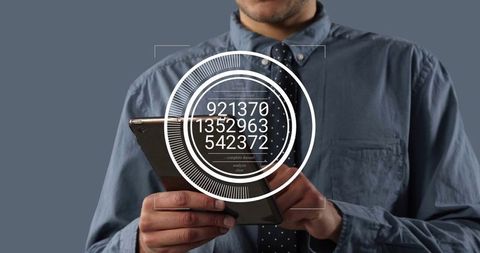 Executive holding tablet interacting with augmented reality HUD displaying numeric data analytics