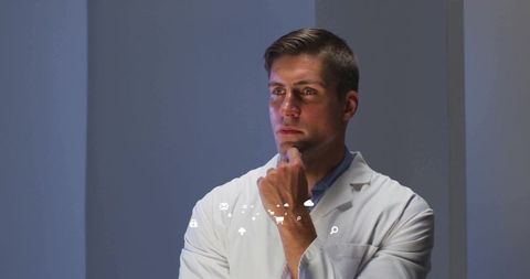 Scientist Featuring Floating Digital Interface Icons in Studio