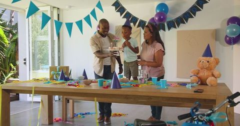 Joyful Family Celebration with Birthday Cake and Decorations at Home