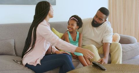 Parents Sharing Pregnancy News with Daughter at Home