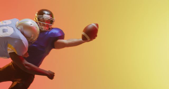 Image of diverse american football players tackling with ball over yellow to orange background. American football, sports and competition concept.