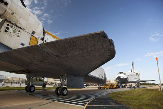 CAPE CANAVERAL, Fla. – The space shuttle Atlantis meets sister shuttle Endeavour in the background for a brief photo opportunity at the Kennedy Space Center in Florida. Endeavour moved from Bay 2 of the Orbiter Processing Facility to switch places with Atlantis which had been in Vehicle Assembly Building VAB. In the VAB, Endeavour will undergo final preparations for its cross-country ferry flight targeted for mid-September. The work is part of Transition and Retirement of the remaining space shuttles, Endeavour and Atlantis. Endeavour is being prepared for public display at the California Science Center in Los Angeles. Endeavour was the last space shuttle added to NASA’s orbiter fleet. Over the course of its 19-year career, Endeavour spent 299 days in space during 25 missions. For more information, visit http://www.nasa.gov/transition Photo credit: NASA/Dimitri Gerondidakis