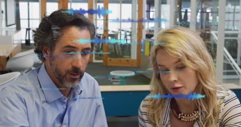 Colleagues Analyzing Data with Futuristic Digital Interfaces in Modern Office