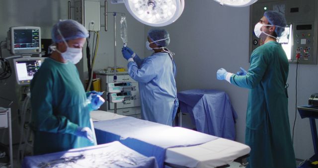 Image of diverse group of surgeons and surgical assistants preparing operating theatre for operation. Hospital, medical and healthcare services.