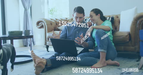 Couple Analyzing Data on Laptop at Home