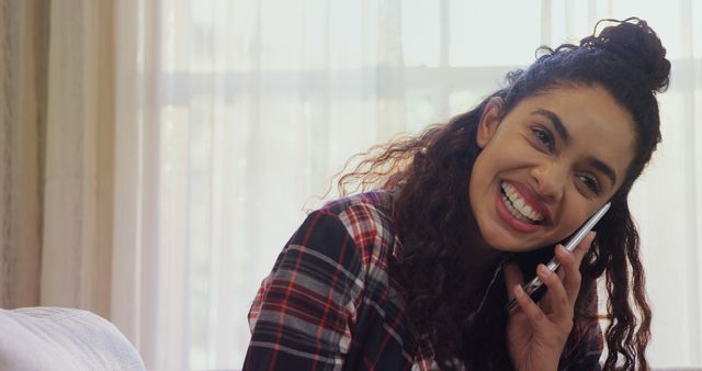 Close-up of woman laughing while talking on phone at home 4K 4k