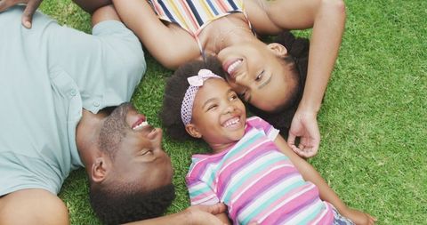 Joyful African American Family Lying on Grass Outdoors