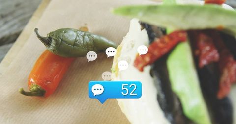 Tortilla wedge with roasted peppers and chilies on kraft paper with blue 52 notification
