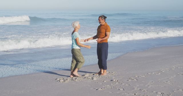 Happy senior caucasian couple holding hands on beach. Senior lifestyle, realxation, nature, free time and vacation.