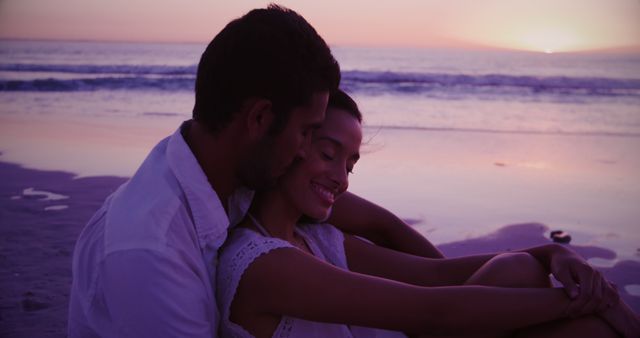 Biracial couple enjoys a beach sunset, with copy space - Download Free Stock Photos Pikwizard.com