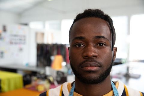 Focused African American Tailor in Creative Sewing Studio Environment