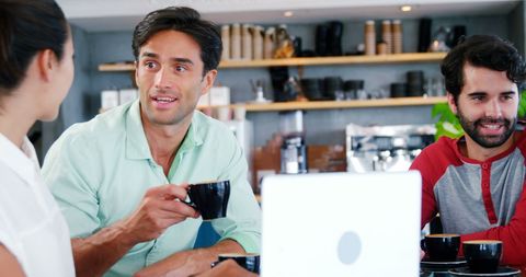 Friends Socializing Over Coffee with Laptop in a Cozy Cafe - Download Free Stock Images Pikwizard.com