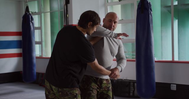 Two Men Practicing Self-Defense Techniques in Gym - Download Free Stock Images Pikwizard.com