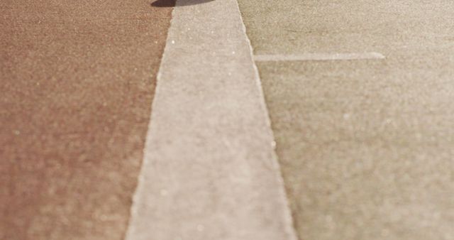 Close-Up of Sundrenched Urban Road with Center Line - Download Free Stock Images Pikwizard.com