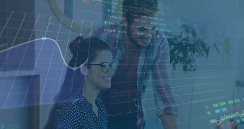 Colleagues analyzing financial charts collaboratively in modern office