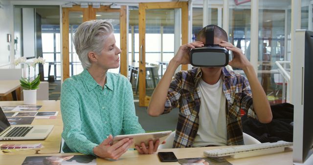 Senior Woman and Young Man Using Virtual Reality and Tablet in Modern Office - Download Free Stock Images Pikwizard.com