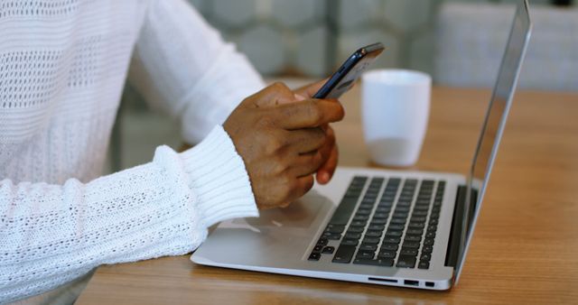 Person Using Smartphone and Laptop at Wooden Table - Download Free Stock Images Pikwizard.com