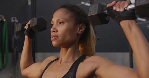 African American Woman Strength Training with Dumbbells